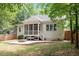 A charming backyard features a screened porch, a stone patio, and a cozy fire pit at 715 Kimbrough St, Raleigh, NC 27608