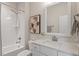 This bathroom features a tub with white subway tile surround, a vanity with marble countertop, and a decorative framed art piece at 715 Kimbrough St, Raleigh, NC 27608