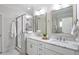 This bright bathroom includes a double sink vanity, quartz countertops, and a walk-in shower at 715 Kimbrough St, Raleigh, NC 27608