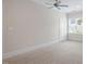 This empty, carpeted bedroom features a large window and ample space to customize at 715 Kimbrough St, Raleigh, NC 27608