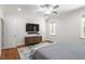 This bedroom features a mounted TV, dresser, and ample natural light from two windows at 715 Kimbrough St, Raleigh, NC 27608