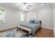 This spacious bedroom offers hardwood floors, a ceiling fan, and ample natural light at 715 Kimbrough St, Raleigh, NC 27608