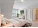 Bright bedroom featuring a large window, dresser, TV, and adjacent bathroom at 715 Kimbrough St, Raleigh, NC 27608