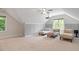 Light-filled bonus room with stylish seating, modern ceiling fan, and decorative paneled accent wall at 715 Kimbrough St, Raleigh, NC 27608