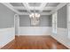 Formal dining room boasting coffered ceilings, wainscoting, and gleaming hardwood floors at 715 Kimbrough St, Raleigh, NC 27608