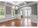 Light-filled dining area showcases coffered ceilings, hardwood floors, and an open, airy feel at 715 Kimbrough St, Raleigh, NC 27608
