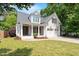 Charming two-story home with white brick, a covered porch, and an attached two-car garage at 715 Kimbrough St, Raleigh, NC 27608