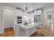 Modern kitchen with white cabinets, granite countertops, stainless steel appliances, and hardwood floors at 715 Kimbrough St, Raleigh, NC 27608