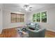 Inviting living room with large windows, a ceiling fan, and comfortable seating, perfect for relaxation at 715 Kimbrough St, Raleigh, NC 27608