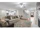 Comfortable living room featuring a decorative rug, a ceiling fan, and hardwood floors at 715 Kimbrough St, Raleigh, NC 27608