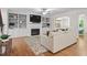 Cozy living room featuring a fireplace, built-in shelves, and hardwood floors at 715 Kimbrough St, Raleigh, NC 27608