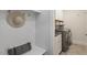 Functional mudroom with built-in bench, storage hooks, and a laundry area with washer and dryer at 715 Kimbrough St, Raleigh, NC 27608