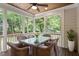 Cozy screened porch with ceiling fan, wood ceiling, and a glass top table surrounded by wicker chairs at 715 Kimbrough St, Raleigh, NC 27608