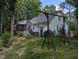 Spacious backyard featuring a swing set and a view of the home's screened porch and deck at 7401 Walnut Grove Ln, Zebulon, NC 27597