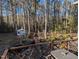 Scenic backyard view with a small bridge, shed, pond, and lush greenery at 7401 Walnut Grove Ln, Zebulon, NC 27597