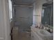 Bright bathroom featuring a glass shower, vanity, and tile floor at 7401 Walnut Grove Ln, Zebulon, NC 27597