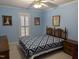 Bedroom featuring traditional furniture, patterned bedding, and window at 7401 Walnut Grove Ln, Zebulon, NC 27597