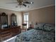 Bedroom featuring traditional furniture, floral bedding, and bright window at 7401 Walnut Grove Ln, Zebulon, NC 27597