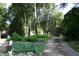 Long driveway leading to a home, complemented by manicured landscaping and mature trees at 7401 Walnut Grove Ln, Zebulon, NC 27597