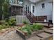 Charming home exterior featuring a screened porch, deck, and beautifully landscaped garden at 7401 Walnut Grove Ln, Zebulon, NC 27597