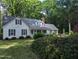 Beautiful two-story home accented by lush landscaping and mature trees in a serene setting at 7401 Walnut Grove Ln, Zebulon, NC 27597
