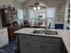 Eat-in kitchen featuring stainless steel sink, wood table, ceiling fan, and large windows at 7401 Walnut Grove Ln, Zebulon, NC 27597