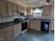 Functional kitchen with wood cabinets, black appliances, and a window for natural light at 7401 Walnut Grove Ln, Zebulon, NC 27597