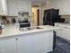 Bright kitchen features white cabinets, stainless steel appliances, and a convenient island with sink at 7401 Walnut Grove Ln, Zebulon, NC 27597