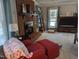 Inviting living room featuring a brick fireplace, plush seating, and ample natural light at 7401 Walnut Grove Ln, Zebulon, NC 27597