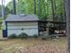 Exterior view of shed featuring a covered area for extra storage at 7401 Walnut Grove Ln, Zebulon, NC 27597