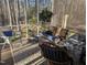 Relaxing sunroom with a porch swing, wicker furniture, and serene views of the backyard at 7401 Walnut Grove Ln, Zebulon, NC 27597