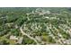 Aerial view displaying a residential area with tree-lined streets and well-maintained homes amidst green surroundings at 831 S White St, Wake Forest, NC 27587