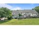 Townhome backyard with grass, a patio, a privacy fence and mature trees at 831 S White St, Wake Forest, NC 27587