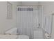 Well-lit bathroom features a shower with patterned curtain and neutral wall color at 831 S White St, Wake Forest, NC 27587