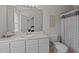 Bathroom with large mirror, white vanity, and shower/tub combo at 831 S White St, Wake Forest, NC 27587