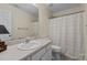 Bright bathroom featuring a vanity, mirror, and shower with a light patterned curtain at 831 S White St, Wake Forest, NC 27587