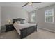 Bedroom features neutral walls, a ceiling fan, and two large windows at 831 S White St, Wake Forest, NC 27587