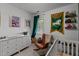 Cozy Bedroom with crib, changing table, rocker, and decorative wall art at 831 S White St, Wake Forest, NC 27587