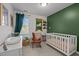 Charming Bedroom with white crib, leather rocking chair, and whimsical decor at 831 S White St, Wake Forest, NC 27587