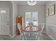 Bright dining room featuring a round table with white chairs and natural light at 831 S White St, Wake Forest, NC 27587