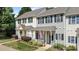 Charming row of townhomes featuring colorful shutters, cozy front porches, and walkways at 831 S White St, Wake Forest, NC 27587