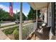 Inviting front porch with wicker seating, lush greenery, and a view of the quiet street at 831 S White St, Wake Forest, NC 27587