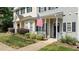 Charming townhome featuring a cozy front porch, walkway, and manicured landscaping at 831 S White St, Wake Forest, NC 27587