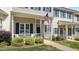 Inviting covered porch with white railings and an American flag, offering curb appeal and charm at 831 S White St, Wake Forest, NC 27587