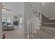 Carpeted stairway leads to a living room with fireplace and comfortable seating at 831 S White St, Wake Forest, NC 27587