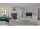 Bright living room features fireplace, neutral walls, and a comfortable gray sofa at 831 S White St, Wake Forest, NC 27587