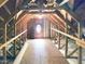 Spacious attic with wood framing, insulation, and a charming circular window at 102 Downing Forest Pl, Cary, NC 27519