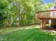 A green backyard with a deck on a sunny day at 102 Downing Forest Pl, Cary, NC 27519