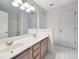 Bathroom with a double sink vanity, large mirror, and toilet area at 102 Downing Forest Pl, Cary, NC 27519