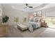 Bedroom with a tray ceiling, ceiling fan, neutral walls and decor, and multiple windows at 102 Downing Forest Pl, Cary, NC 27519
